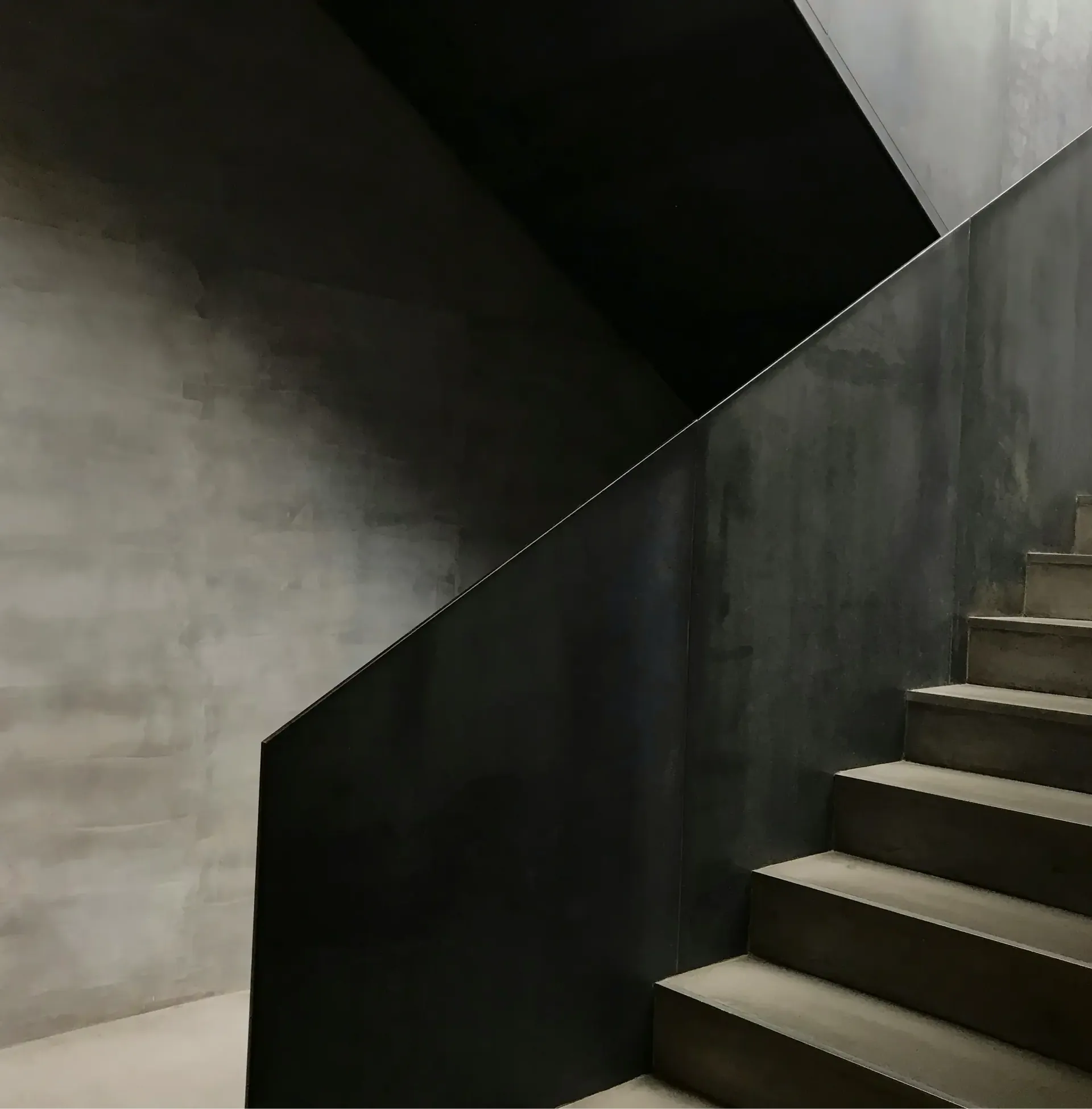 A sculpted stone staircase in shadow